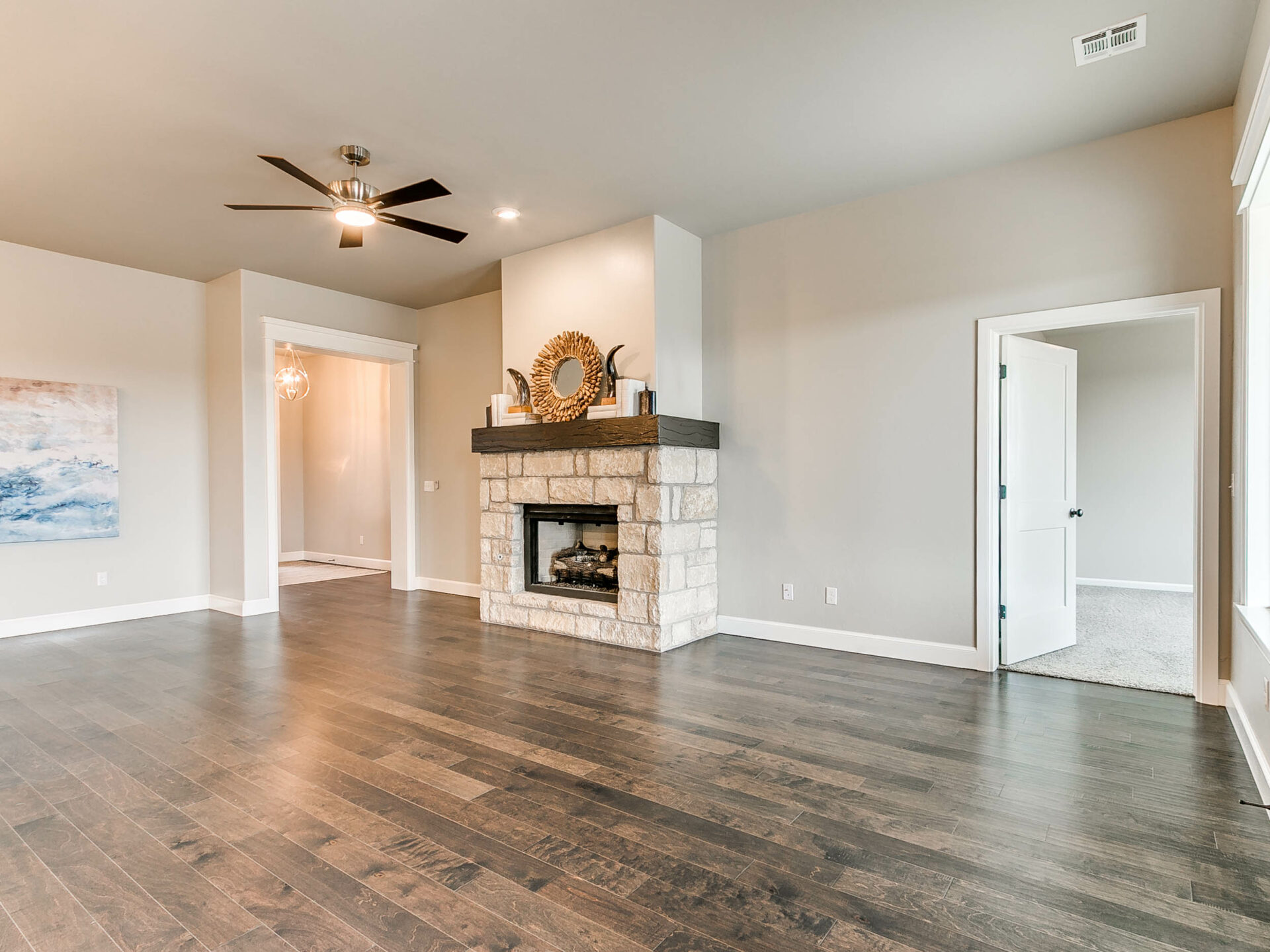 living room, fireplace, new construction, stone fireplace, wood flooring, interior design, homes in Norman, Norman OK
